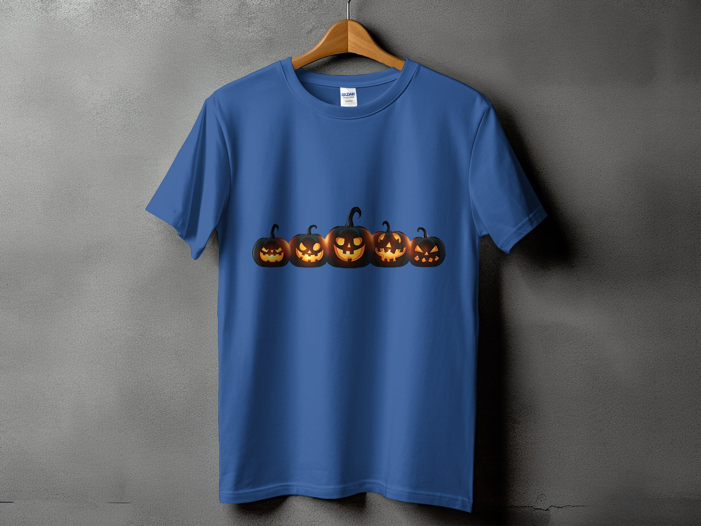 Blue t-shirt with a row of five glowing jack-o'-lanterns across the chest.