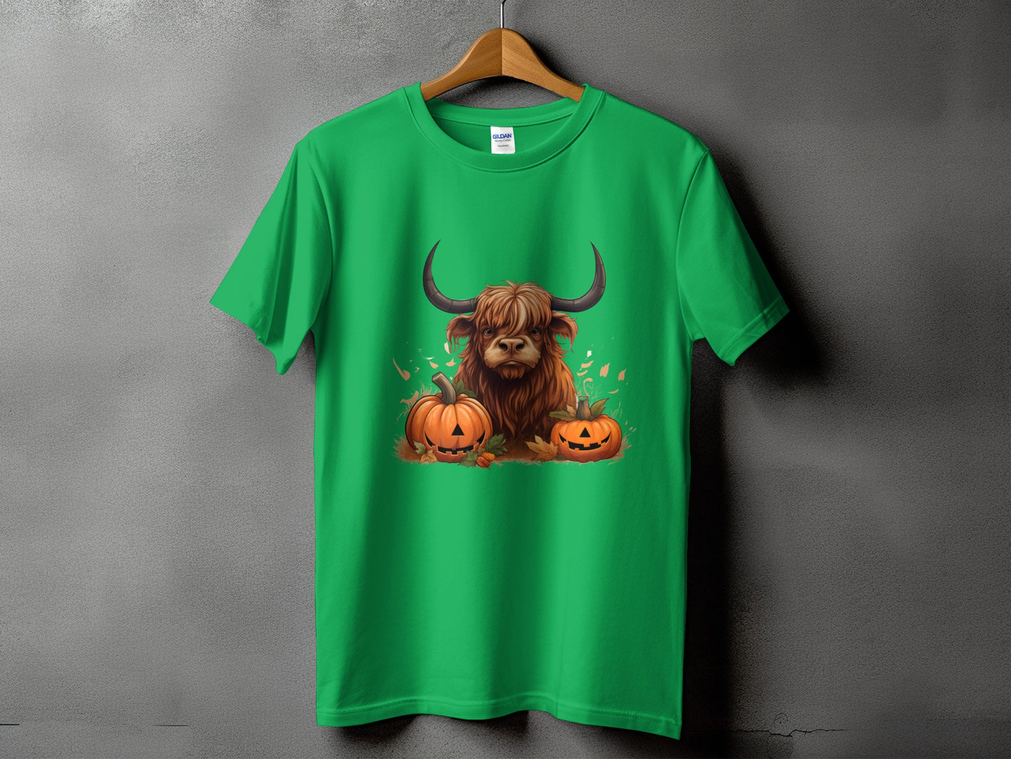 Green t-shirt with Highland cow and two jack-o'-lanterns graphic.