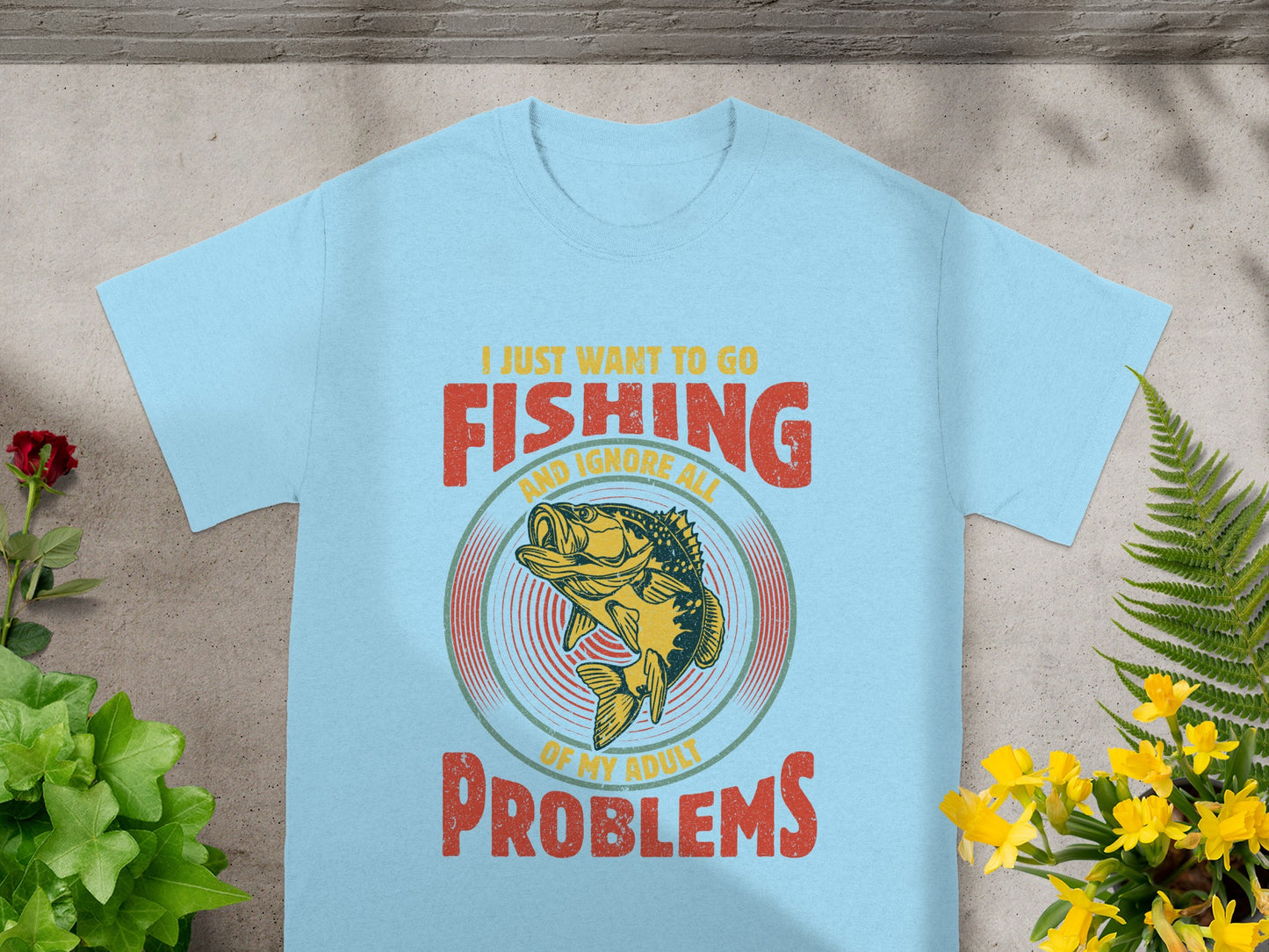 Light blue t-shirt with "I just want to go fishing and ignore all of my adult problems" text and fish graphic.