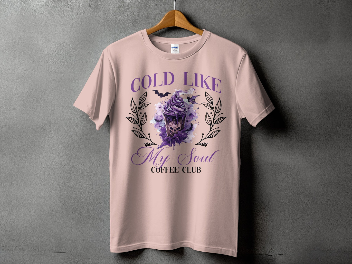 Pink t-shirt with "Cold Like My Soul Coffee Club" text and spooky graphic.