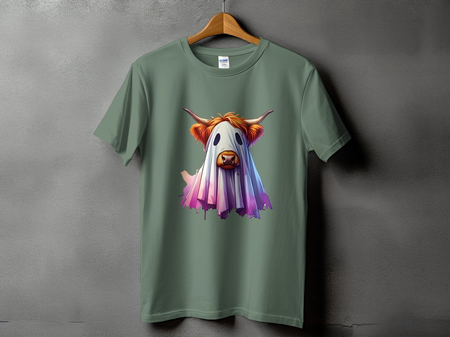 Green t-shirt with a Highland cow dressed as a ghost illustration.