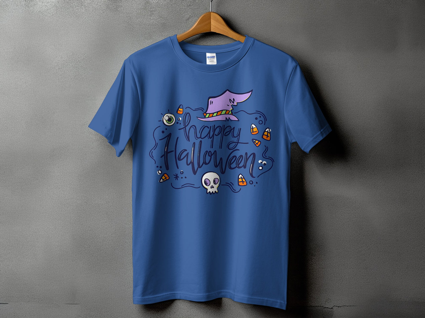Blue t-shirt with a purple witch hat, skull, eye, and candy corn graphic.
