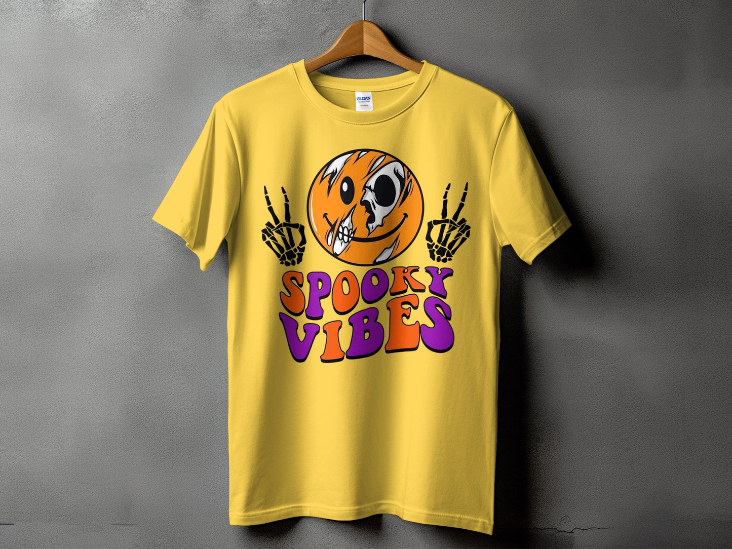 Yellow t-shirt with skull smiley, skeleton hands, and text "Spooky Vibes".