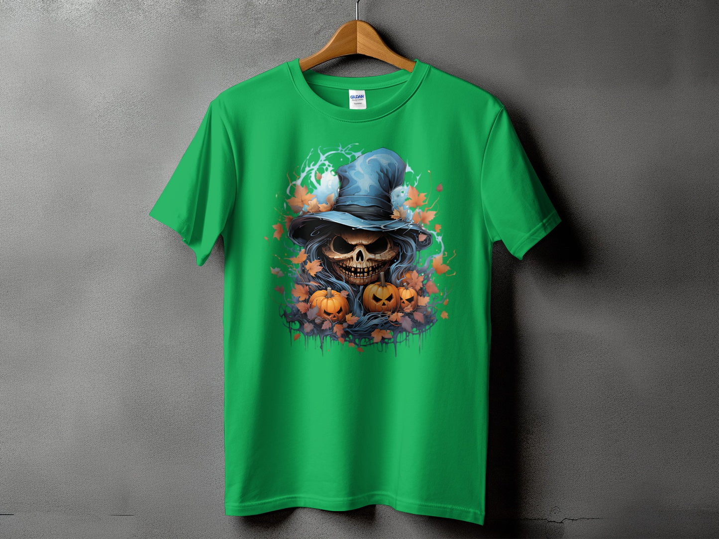 Green t-shirt with a skull wearing a witch hat, pumpkins, and autumn leaves design.