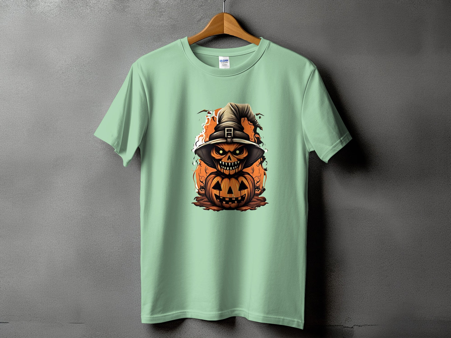 Light green t-shirt with a scary jack-o'-lantern and witch hat Halloween graphic.
