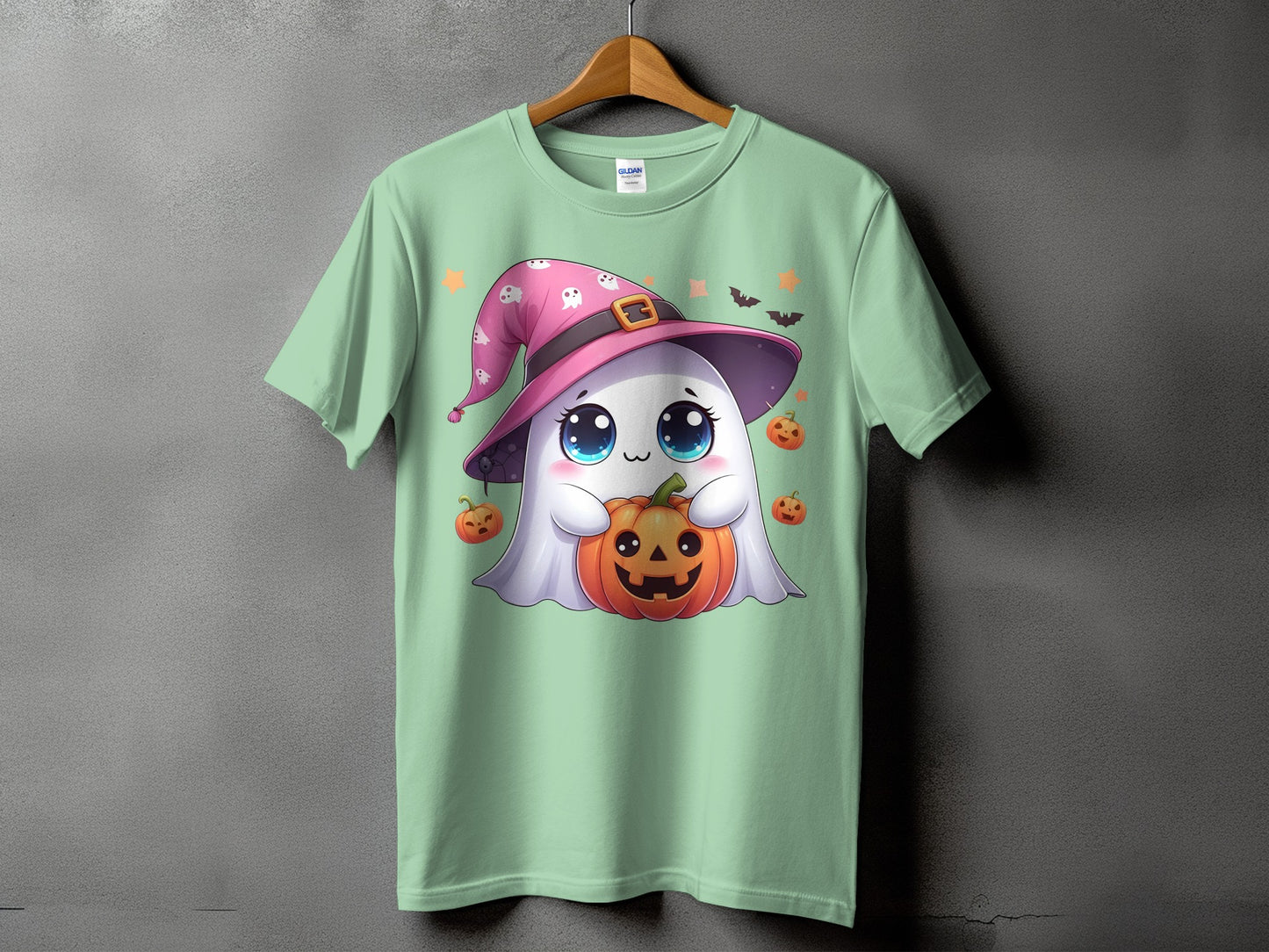 Green t-shirt with a cute ghost wearing a witch hat holding a pumpkin.