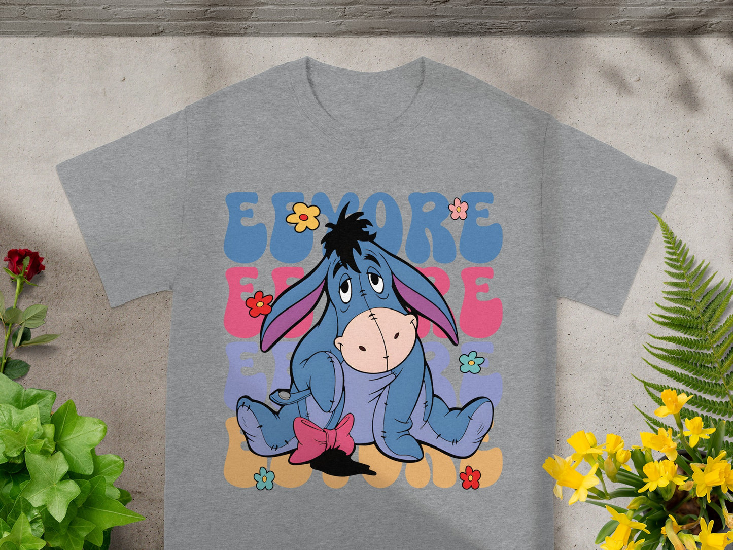 Eeyore sits on a pastel background with "Eeyore" text.