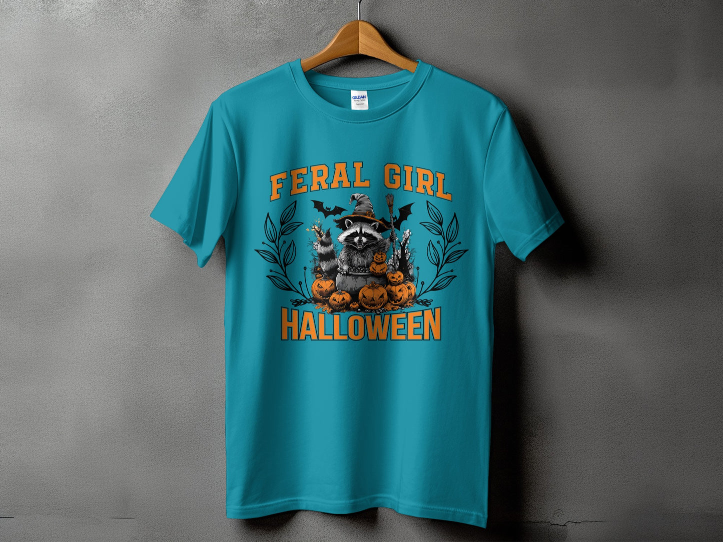Teal t-shirt with "Feral Girl Halloween" text and raccoon graphic.