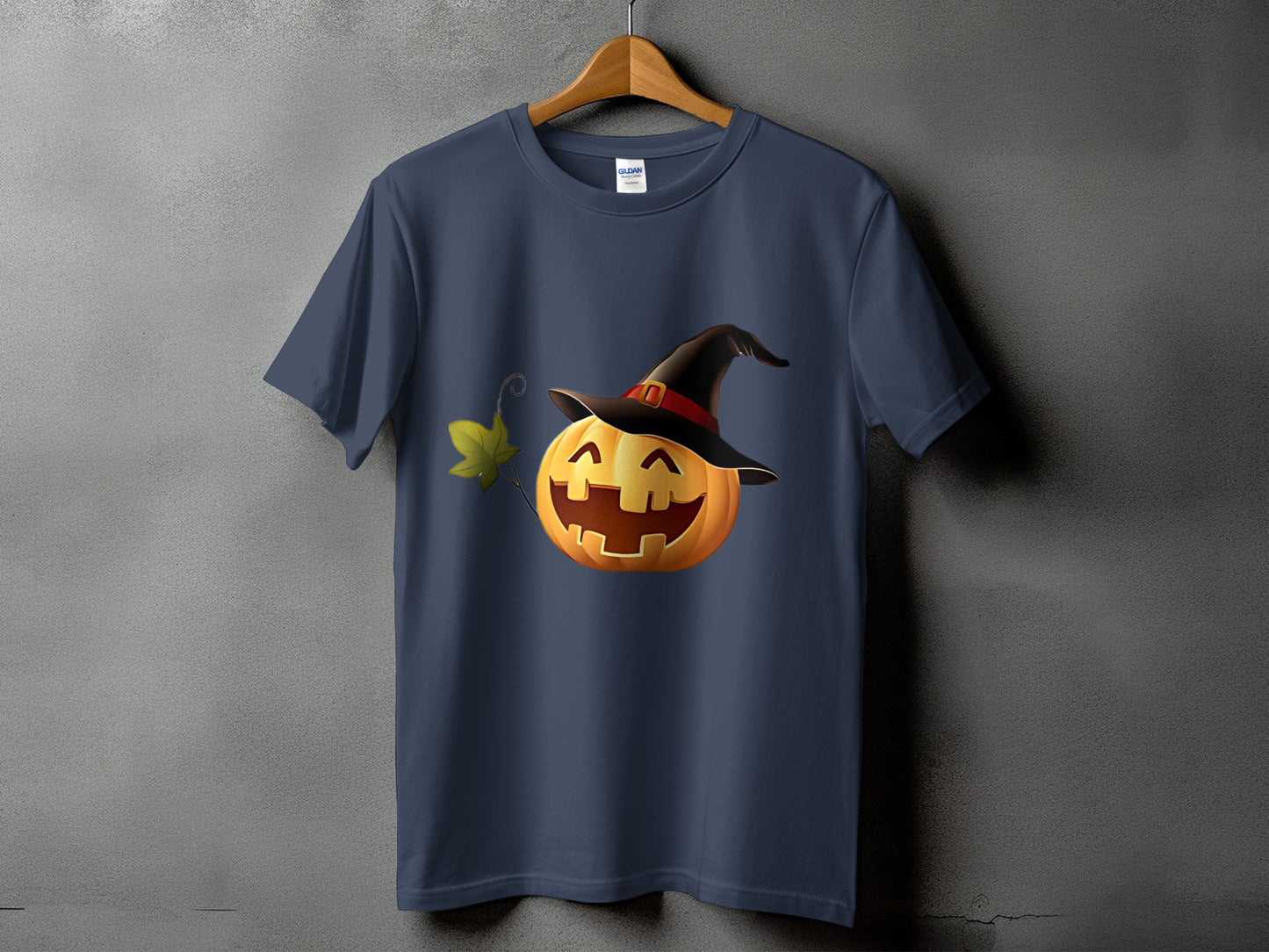 Navy t-shirt with a smiling jack-o'-lantern wearing a witch hat and a green leaf.