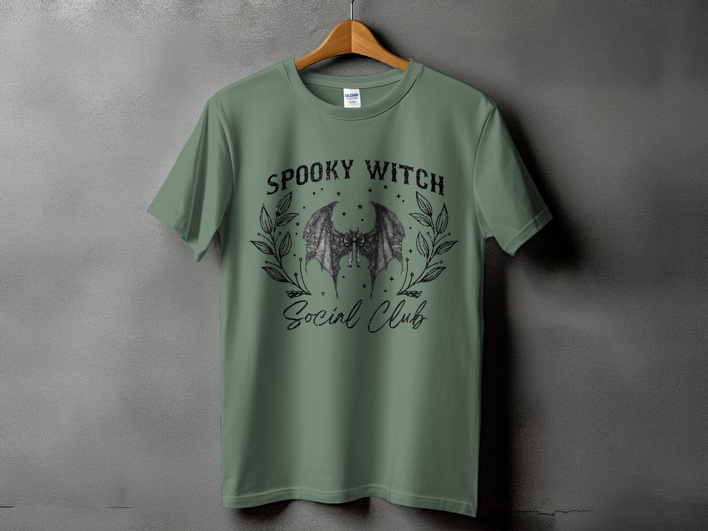 Green t-shirt with a bat graphic and text "Spooky Witch Social Club".