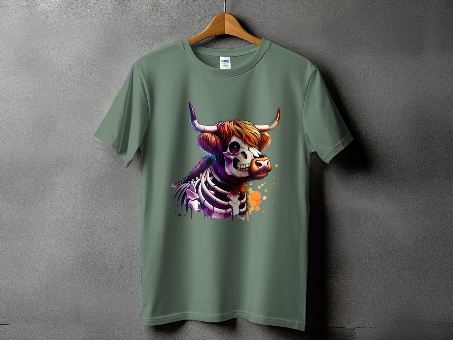 Green t-shirt with skeleton highland cow graphic and colorful paint splatter.
