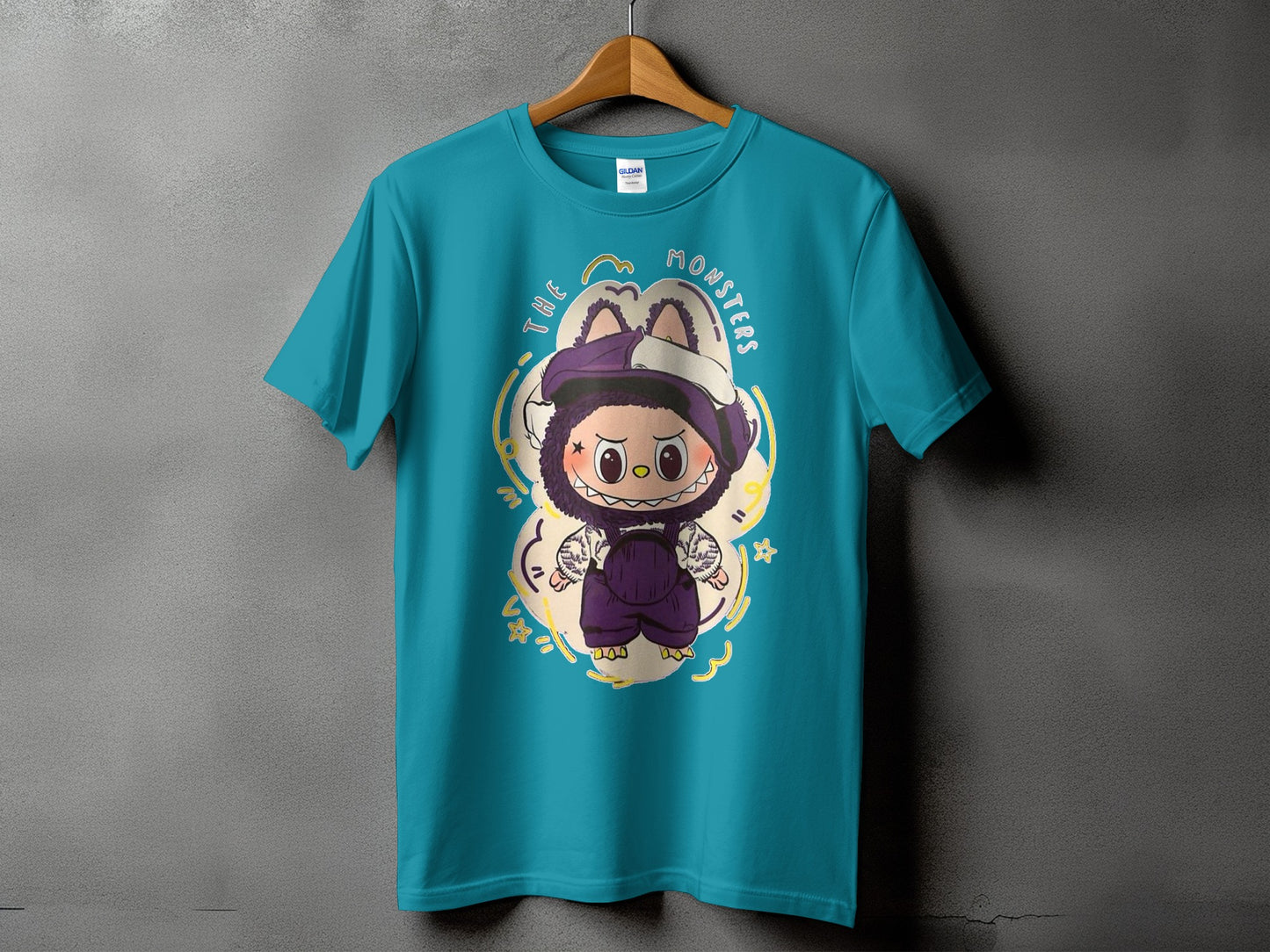 Teal t-shirt with cartoon monster graphic and text "THE MONSTERS".