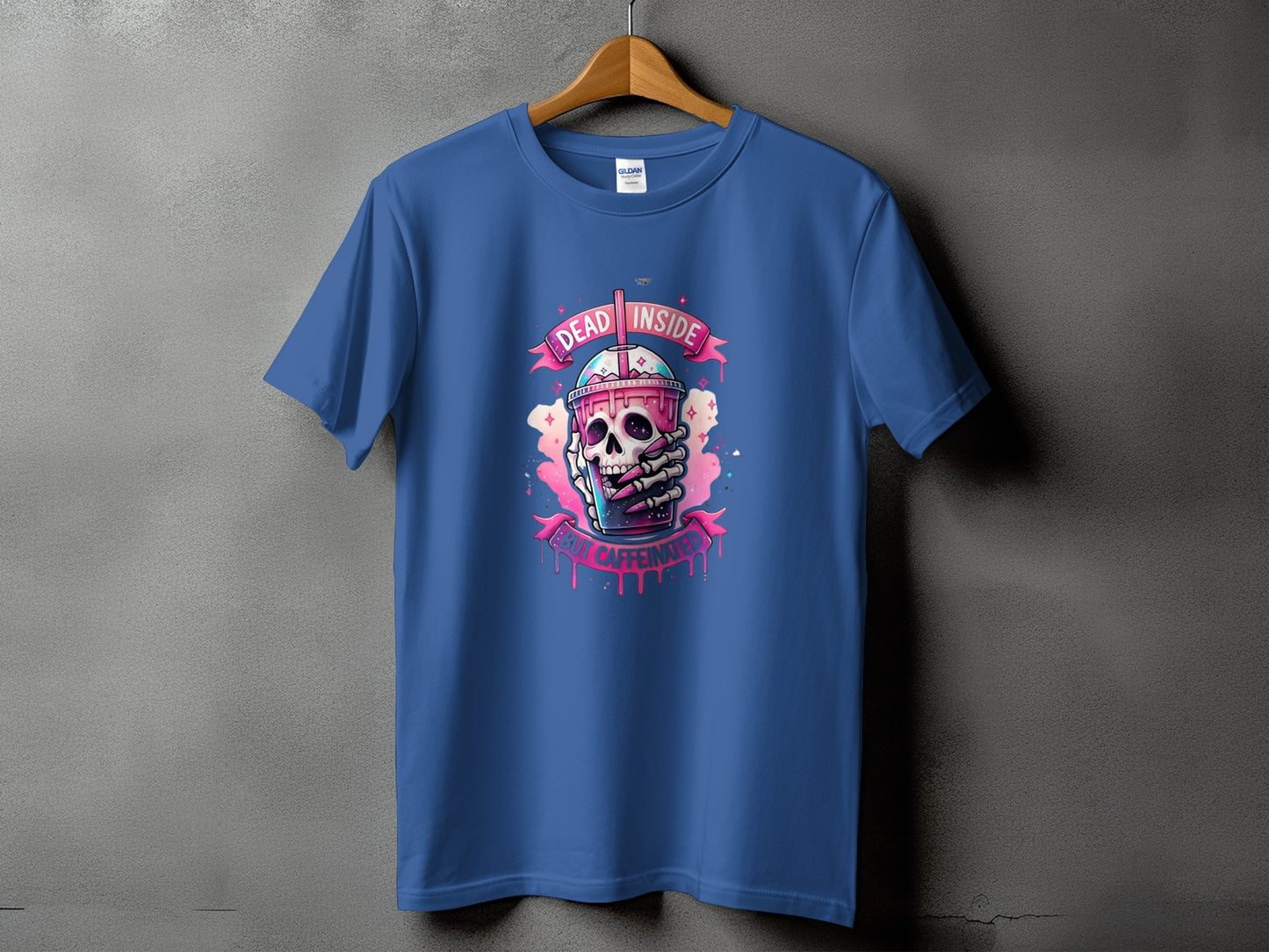 Blue t-shirt with graphic of skull holding coffee cup, reading "DEAD INSIDE BUT CAFFEINATED."