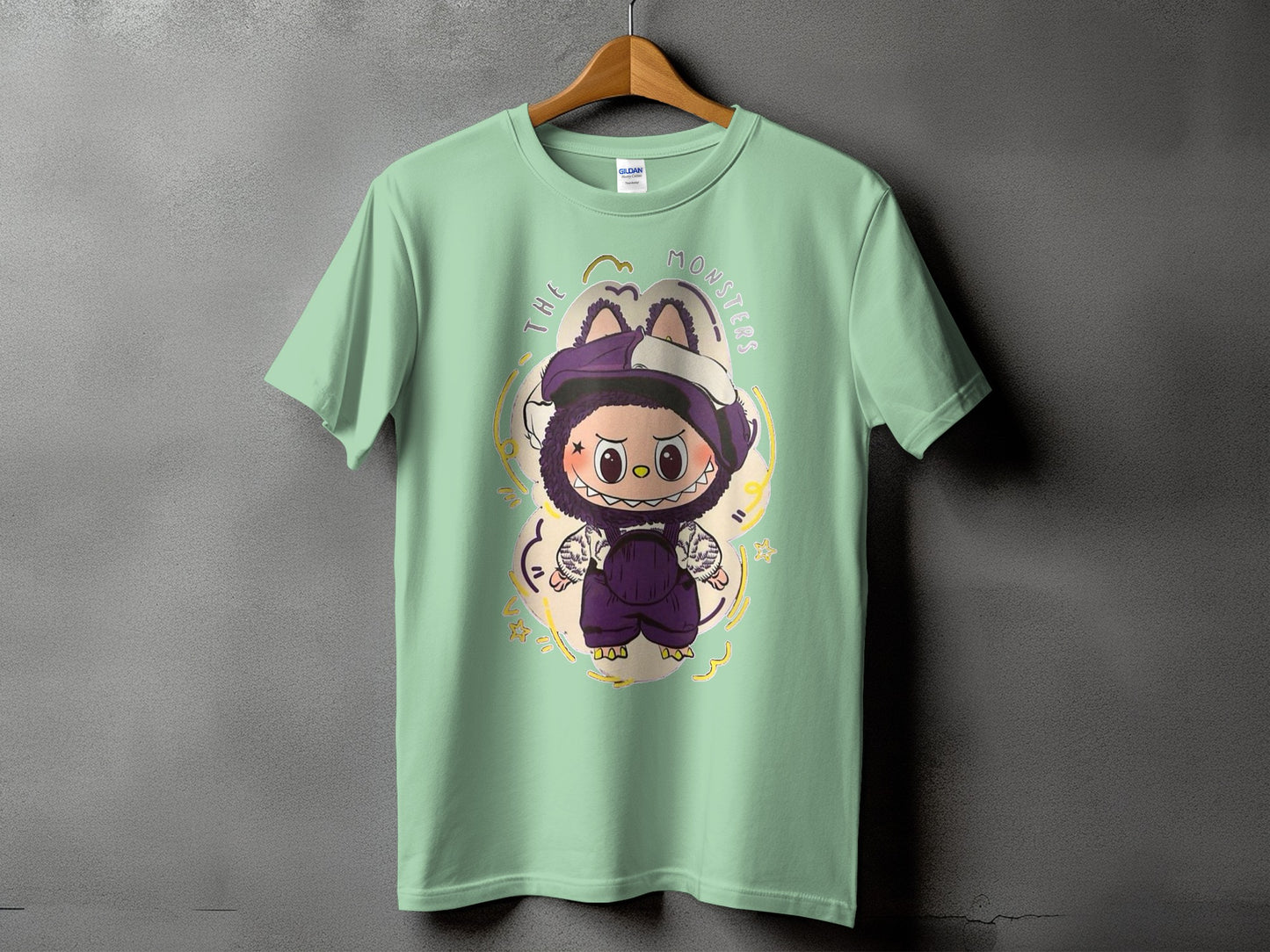 Light green t-shirt featuring a cartoon monster graphic with "THE MONSTERS" text.