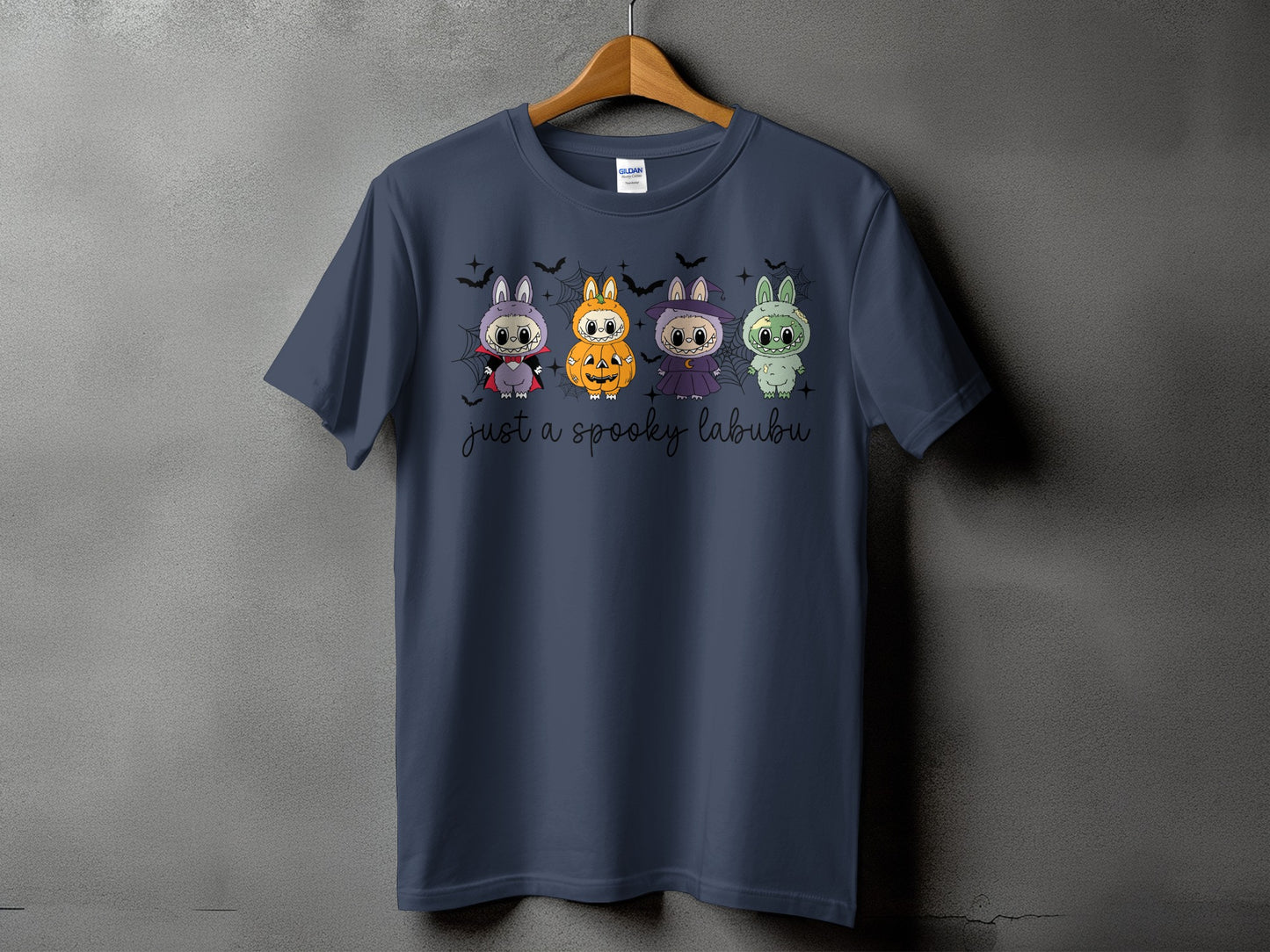 Dark blue t-shirt with four Halloween-themed cartoon characters and text.