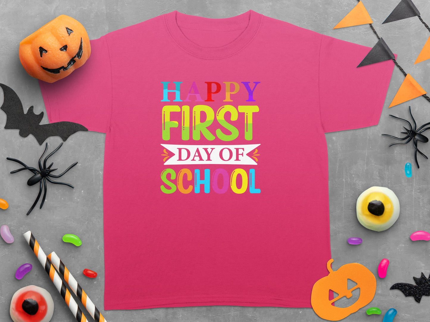 Pink t-shirt with "Happy First Day Of School" in colorful text.