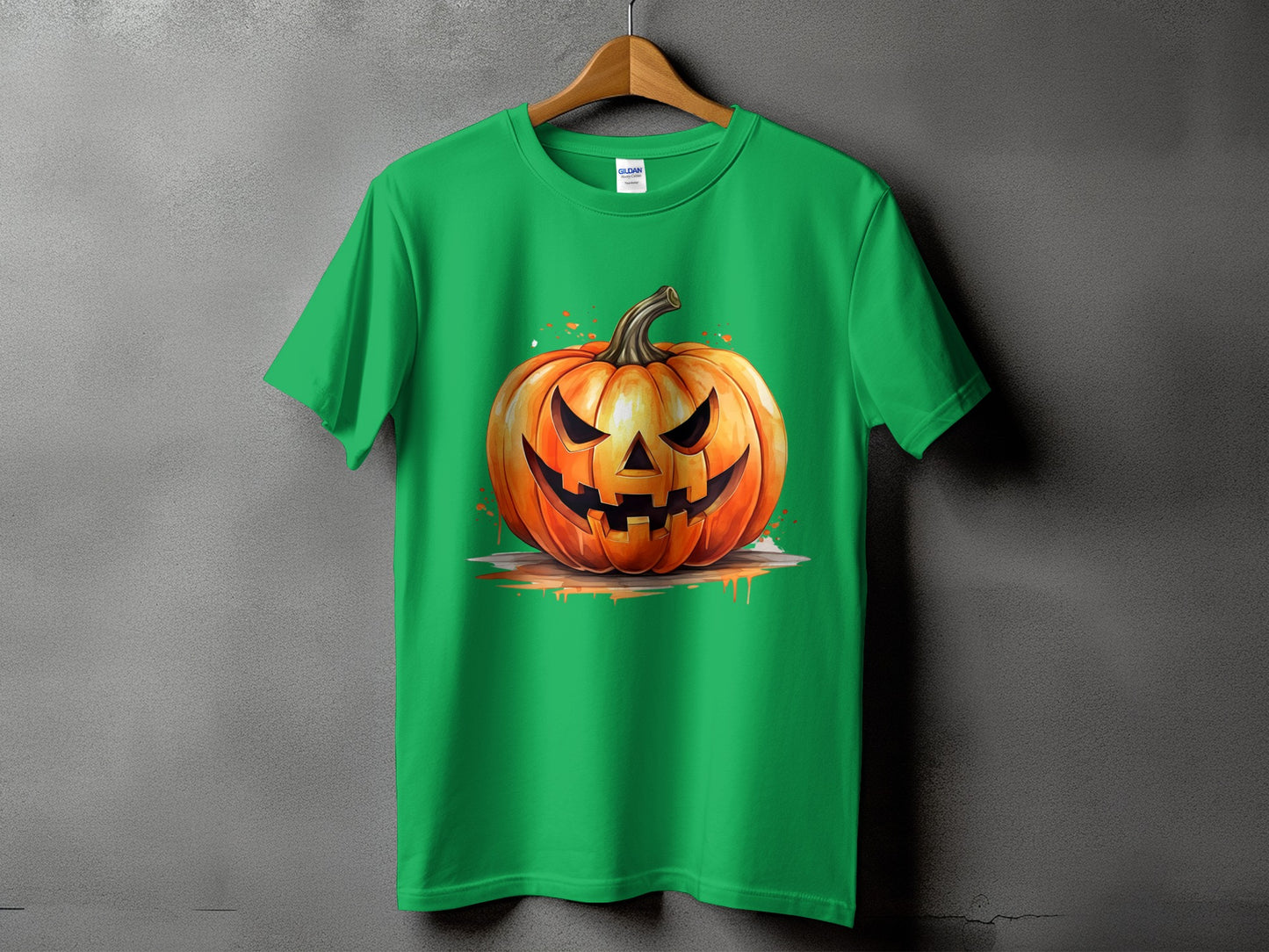 Green t-shirt with a graphic of a carved Halloween pumpkin with a spooky face.
