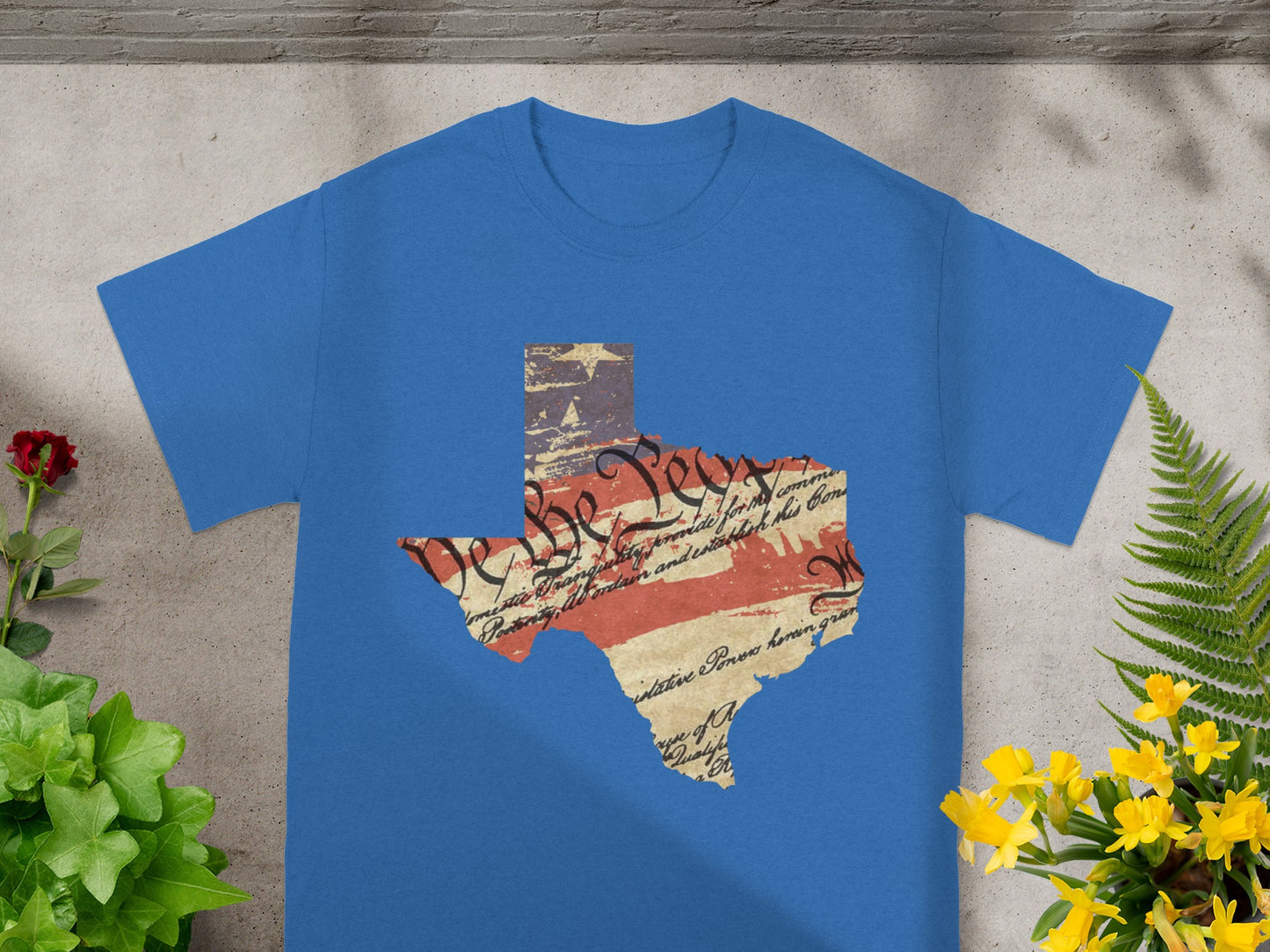 Blue t-shirt with Texas shape featuring faded US flag and historical text.