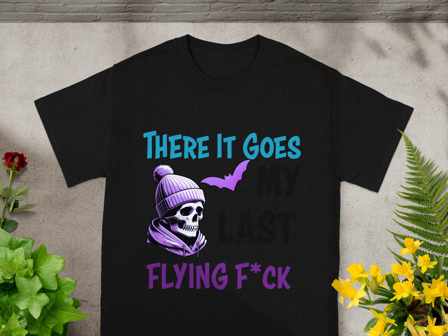 Black t-shirt with skull, bat, and text "THERE IT GOES MY LAST FLYING F*CK".