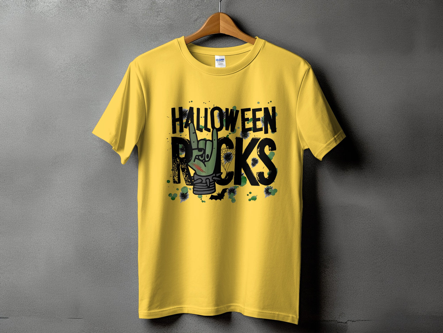 Yellow t-shirt with black text "HALLOWEEN ROCKS" and a zombie hand giving a rock-on gesture.