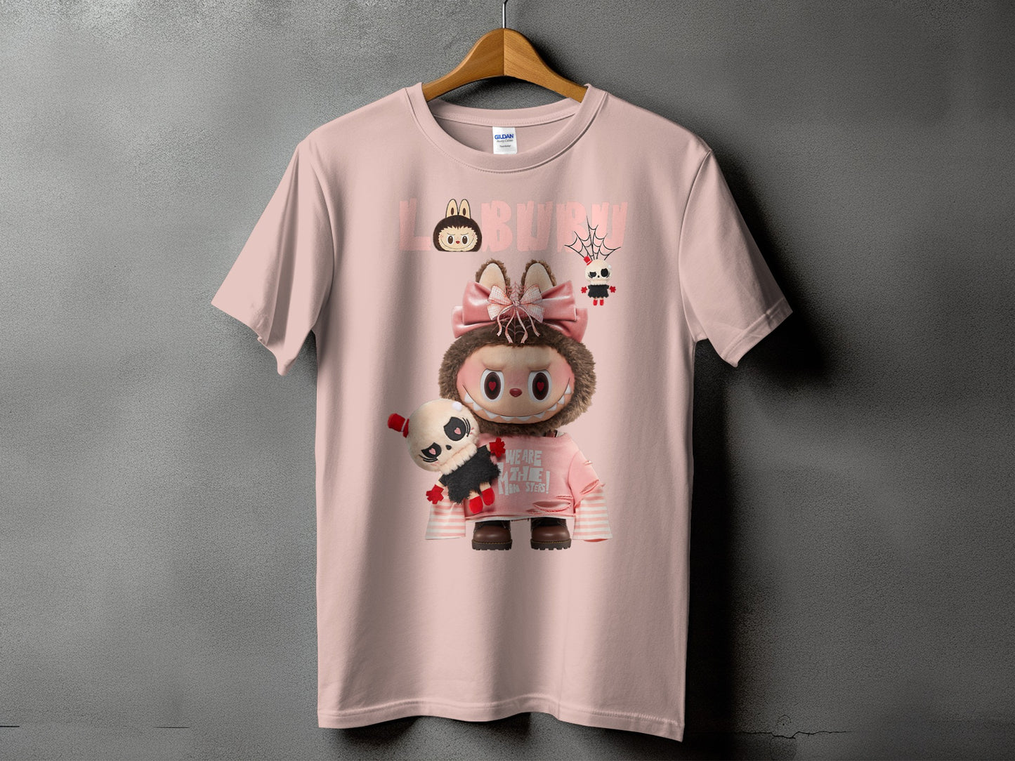 Pink t-shirt with cartoon character holding a stuffed panda, text reads "LABBBU".