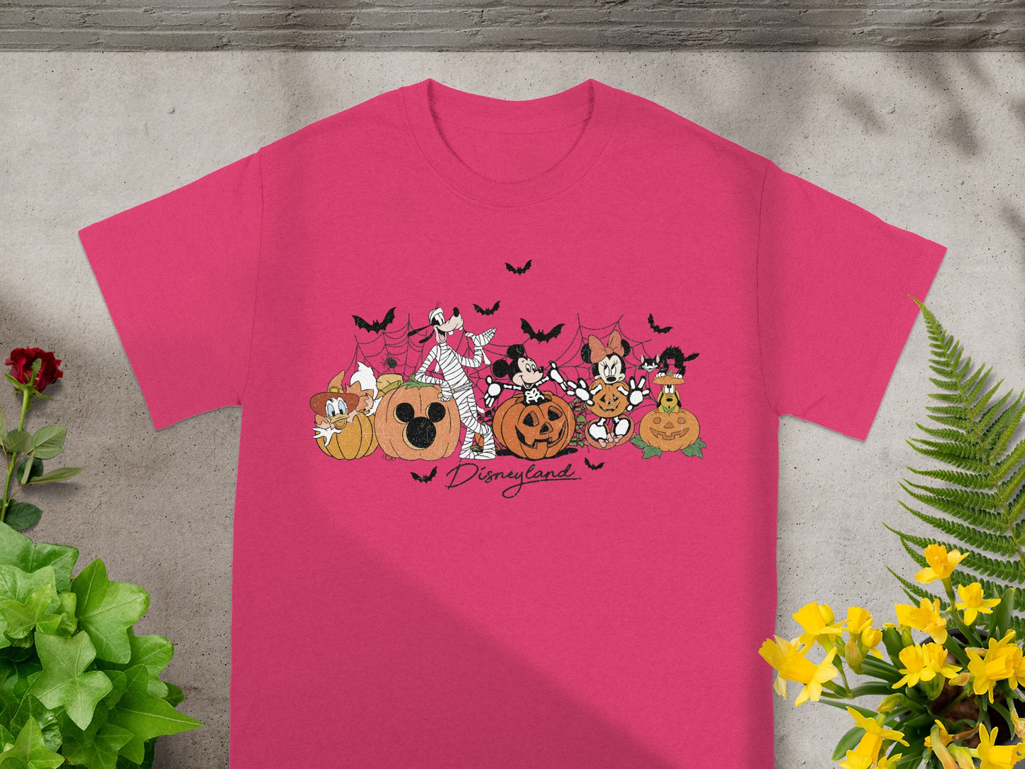 Pink t-shirt with Disneyland Halloween characters and pumpkins graphic.