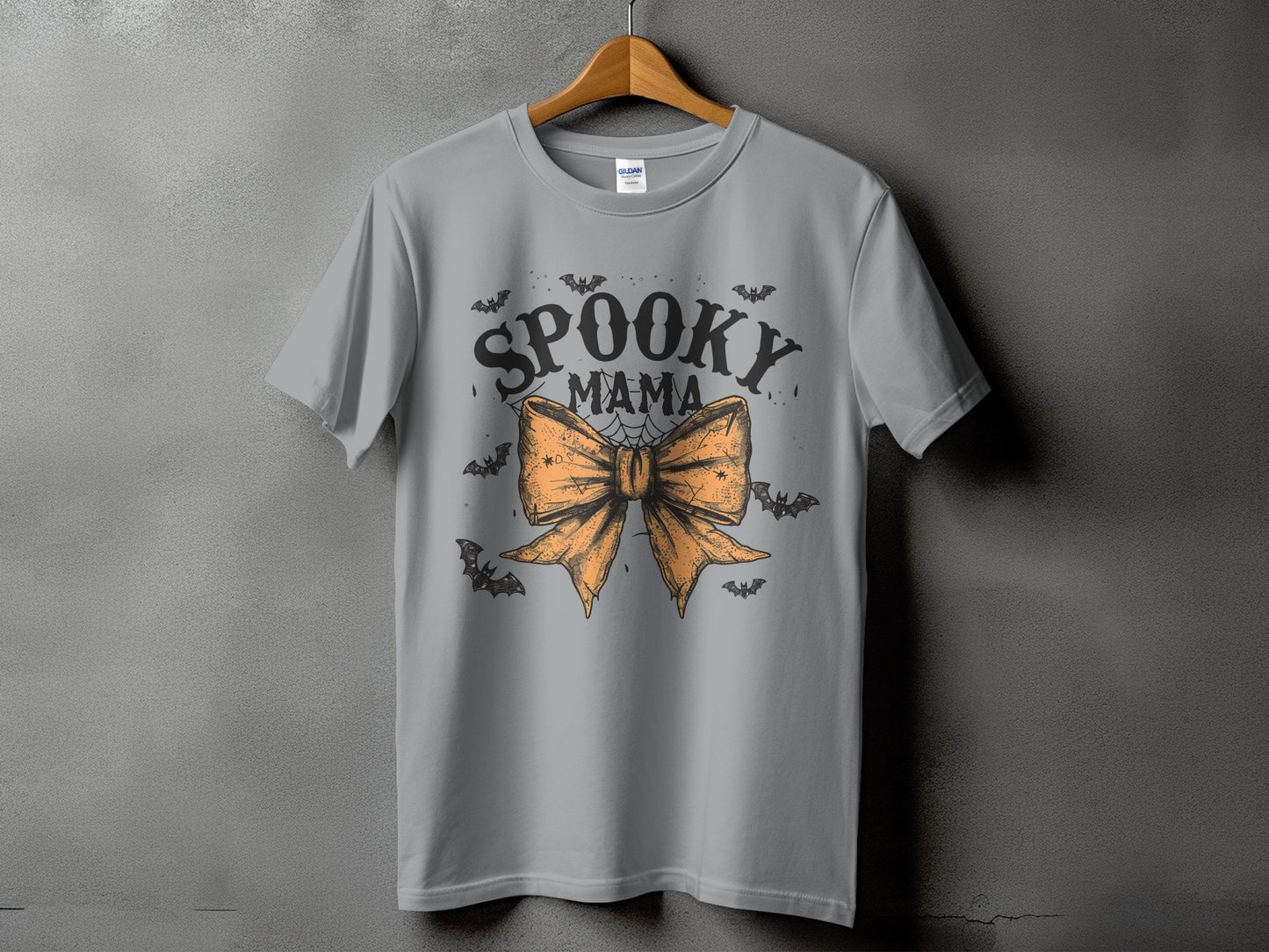 Gray t-shirt with "Spooky Mama" text and an orange bow with bats.
