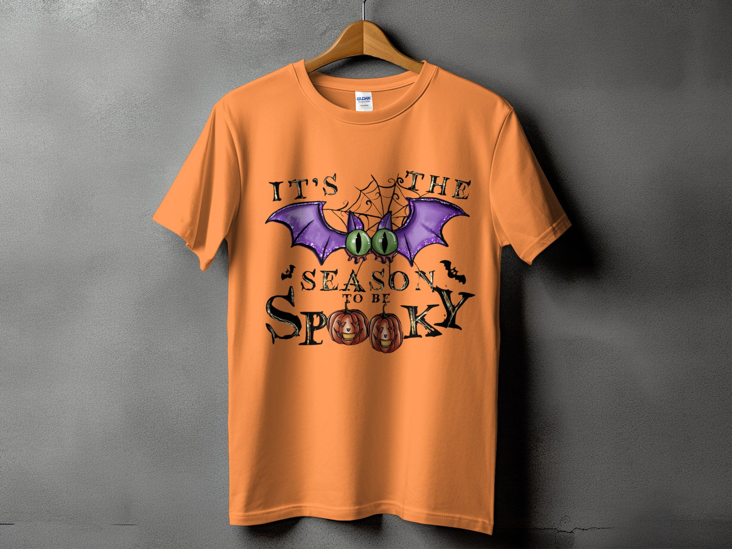 Orange t-shirt with Halloween graphic and text "IT'S THE SEASON TO BE SPOOKY".