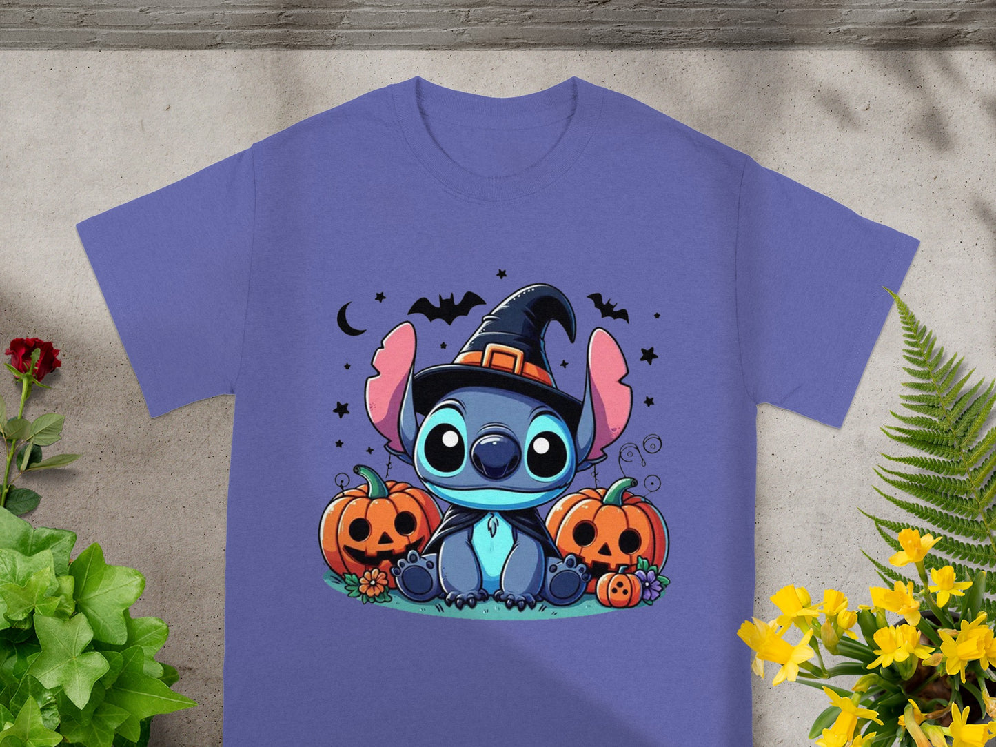Stitch in witch hat with pumpkins and bats on purple t-shirt.