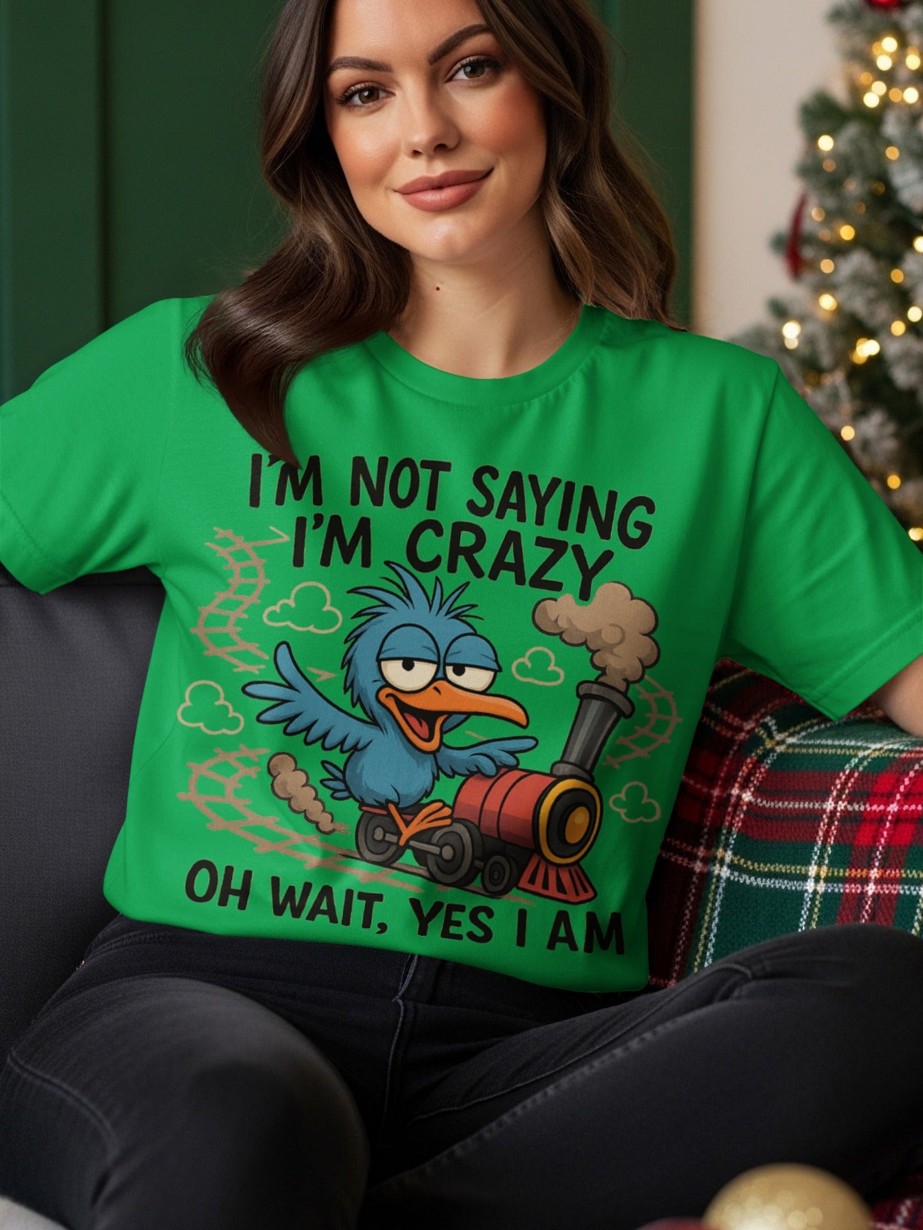 Green t-shirt with cartoon blue bird on a train, text "I'm not saying I'm crazy oh wait, yes I am."
