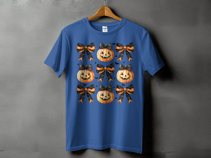 Blue t-shirt with repeating pattern of jack-o'-lanterns and Halloween bows.