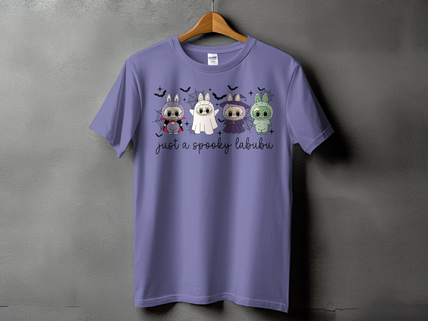Purple t-shirt with four cartoon bunnies in Halloween costumes and "just a spooky labubu" text.
