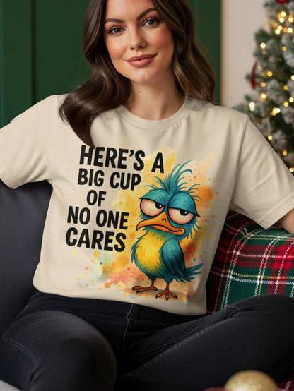 Cream t-shirt with blue bird graphic and text "Here's a big cup of no one cares".