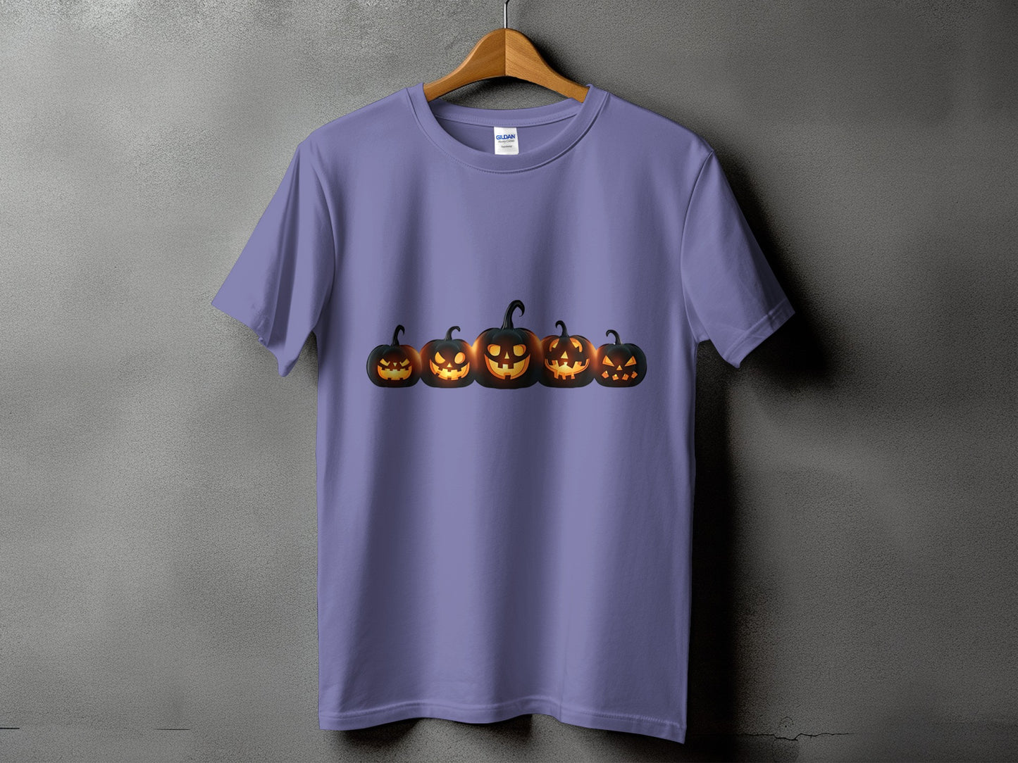 Lavender t-shirt with a row of five glowing jack-o'-lanterns.