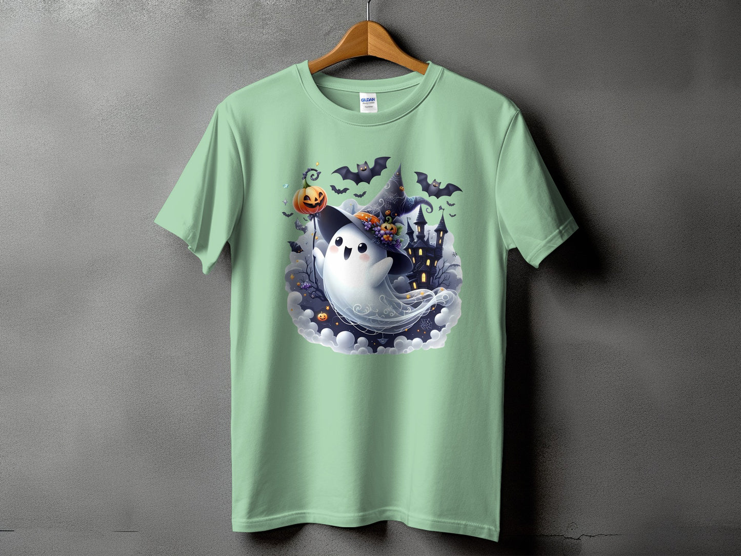 Mint t-shirt with a cute ghost wearing a witch hat and holding a pumpkin on a stick.