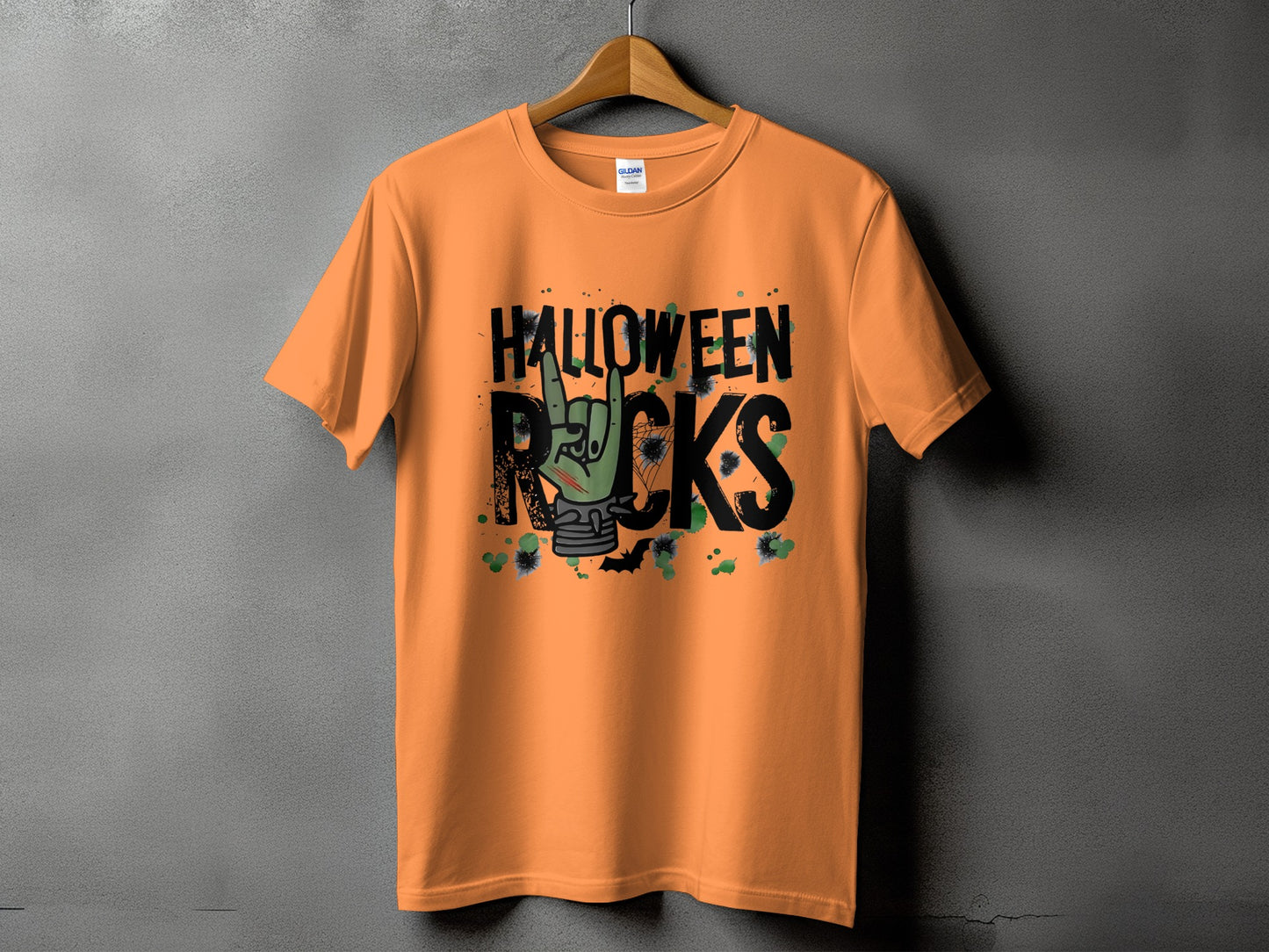 Orange t-shirt with "Halloween Rocks" text and a green zombie hand giving the rock-on sign.