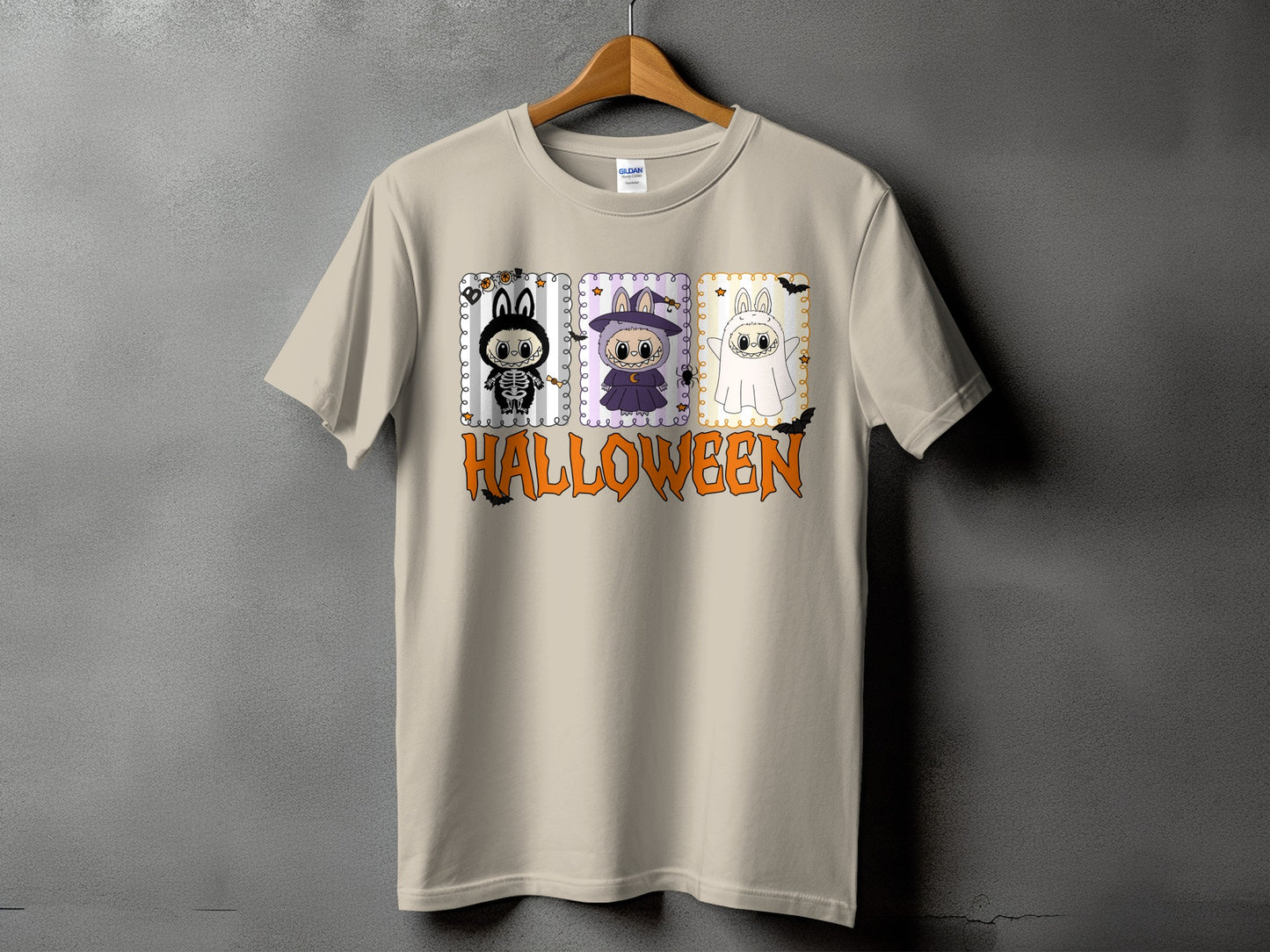 Light tan t-shirt with Halloween graphic featuring three costumed bunnies and the word Halloween.