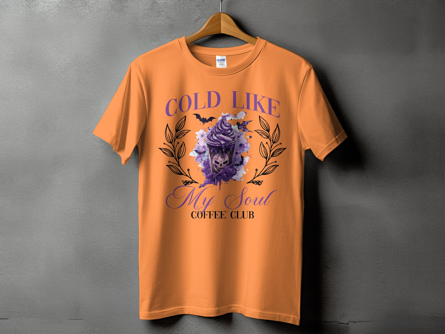 Orange t-shirt with "COLD LIKE My Soul COFFEE CLUB" text and a spooky drink graphic.