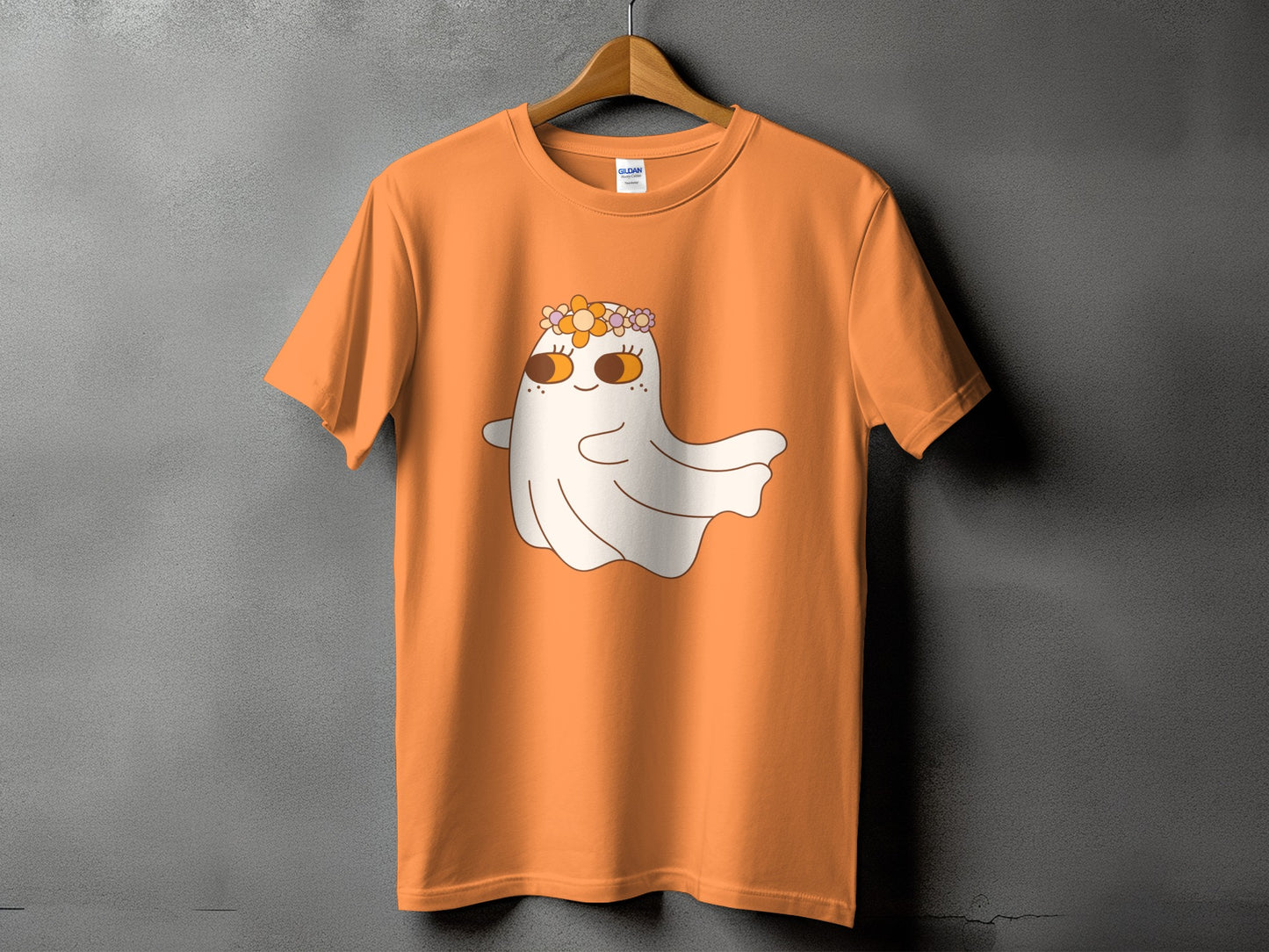 Orange t-shirt with a cute ghost wearing a flower crown graphic.