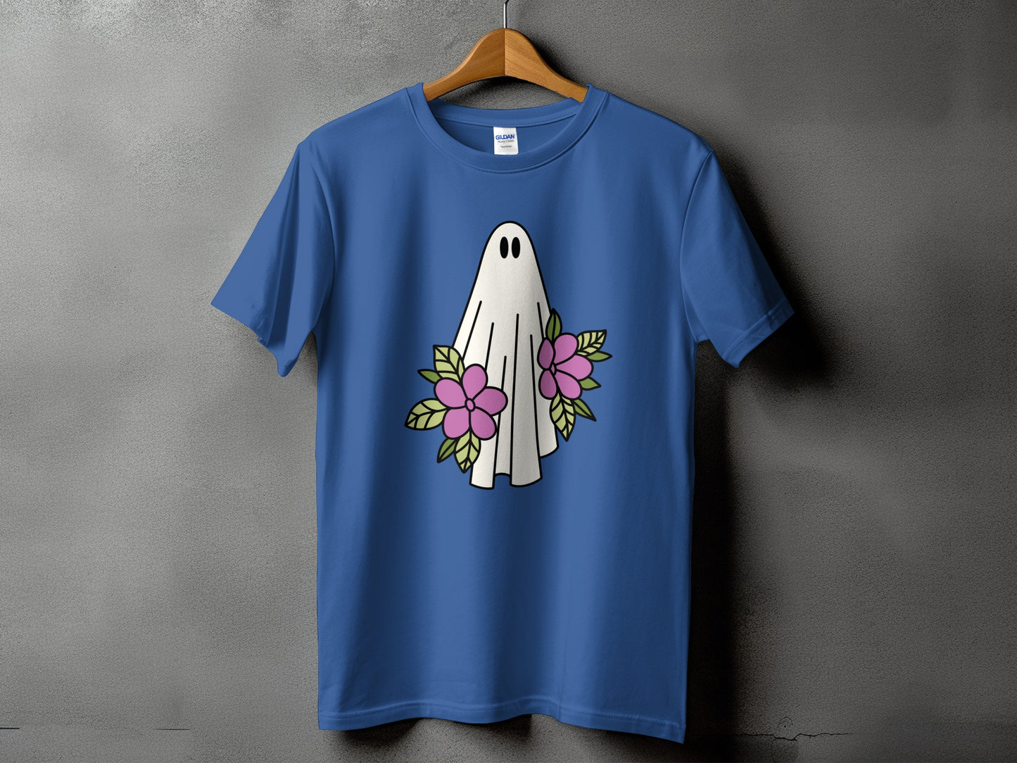 Blue t-shirt with a white ghost and pink flowers graphic on the front.