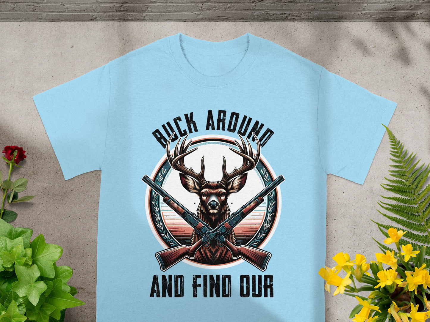 Light blue t-shirt with deer, crossed rifles, and text "BUCK AROUND AND FIND OUR".
