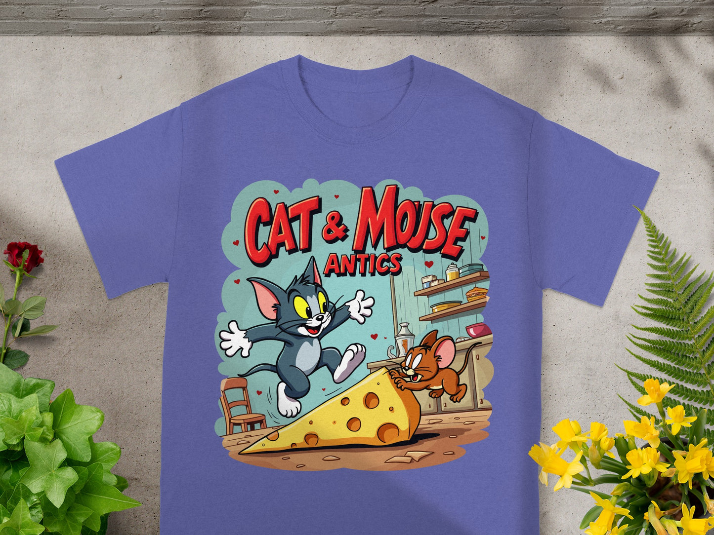 Tom and Jerry chasing cheese on a purple t-shirt with "Cat & Mouse Antics" text.