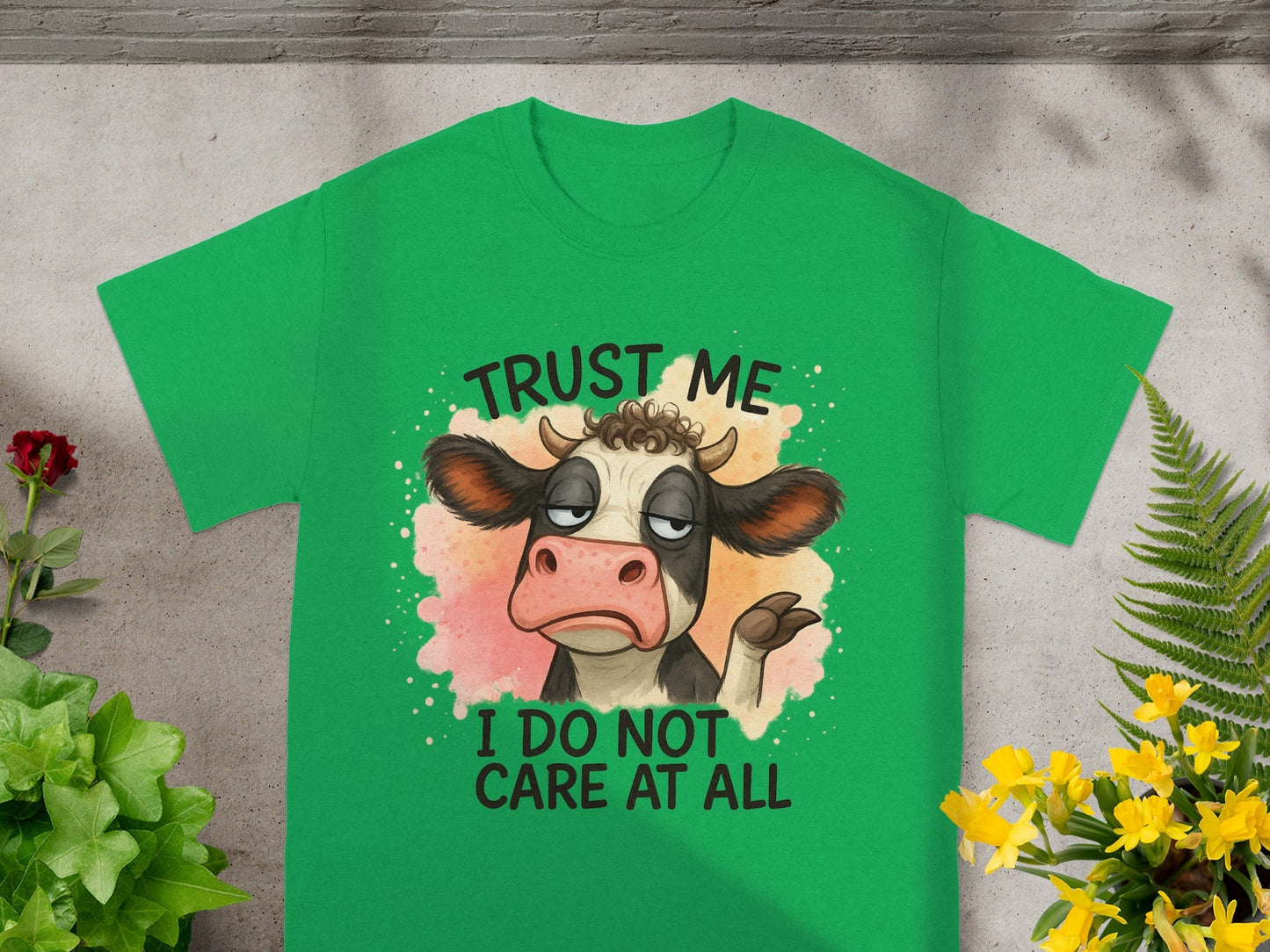 Green t-shirt with cartoon cow and text "Trust me, I do not care at all."