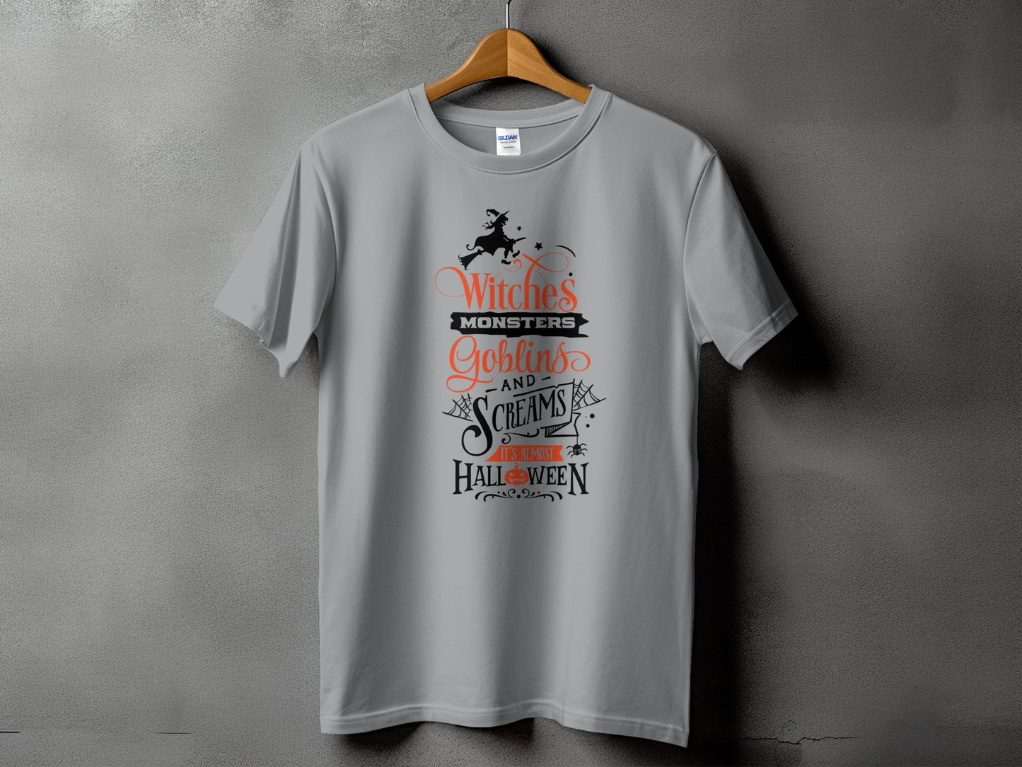 Grey t-shirt with "Witches Monsters Goblins and Screams It's Almost Halloween" text.