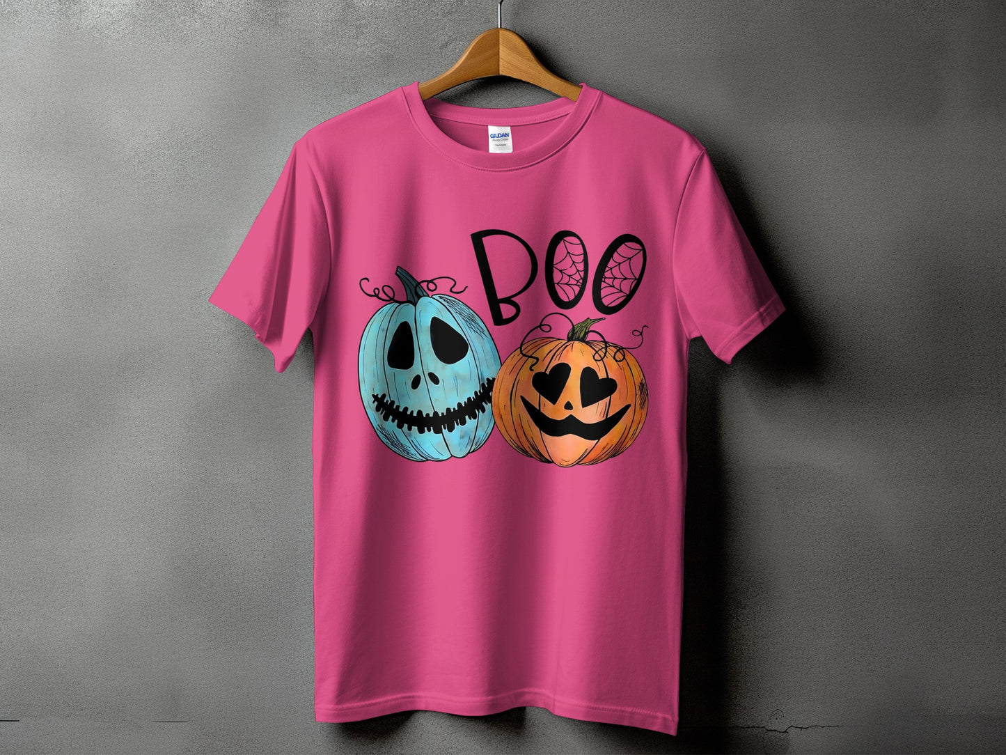 Pink t-shirt with "BOO" text and two jack-o'-lanterns, one blue and one orange.