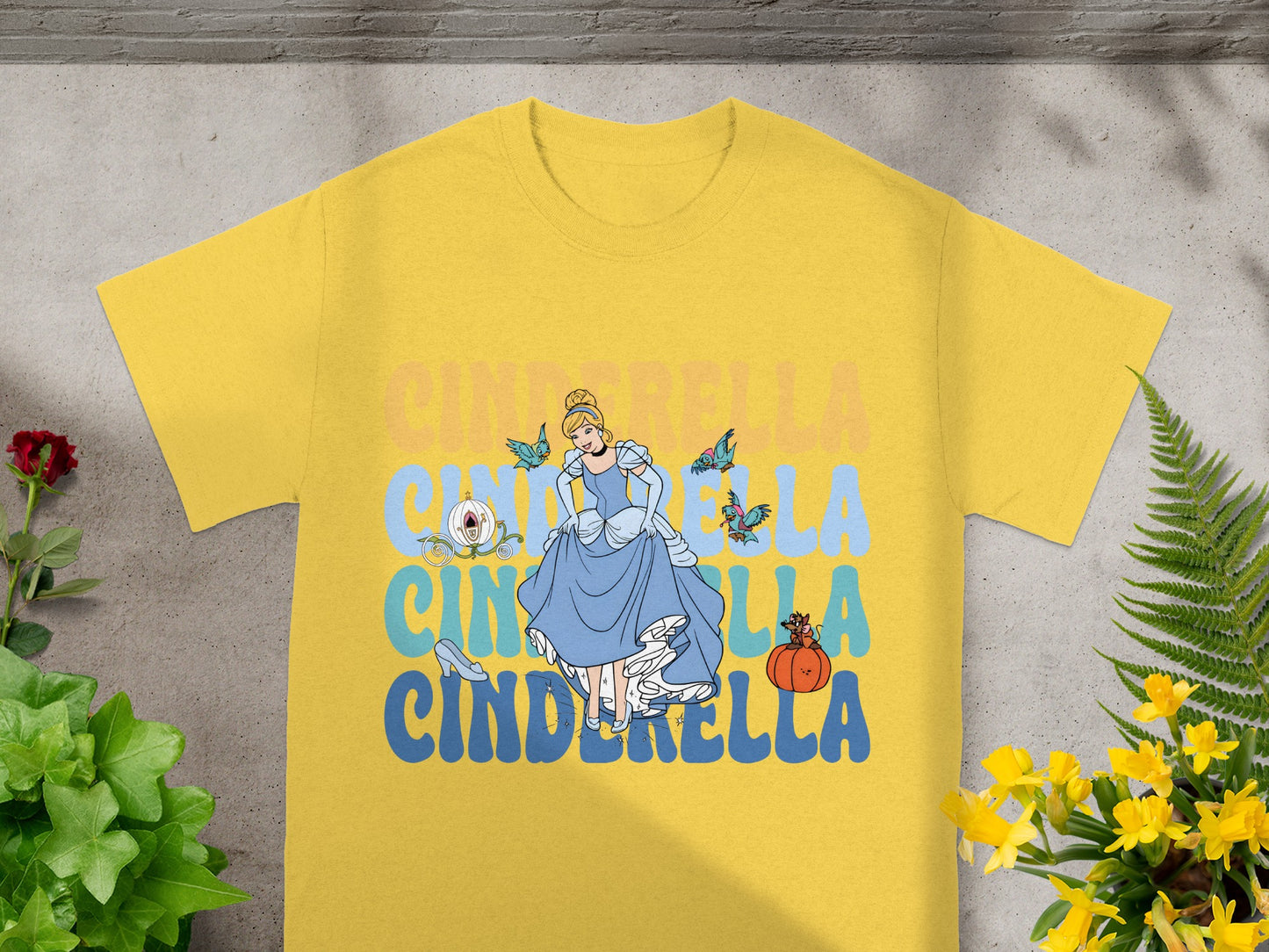 Yellow t-shirt with Cinderella and pumpkins graphic.