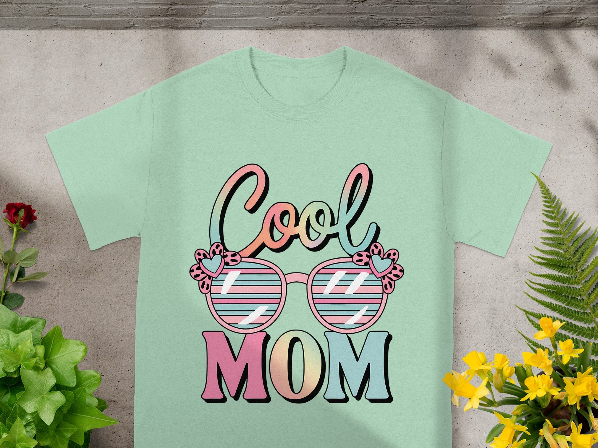 Light green t-shirt with "Cool Mom" text and sunglasses design.