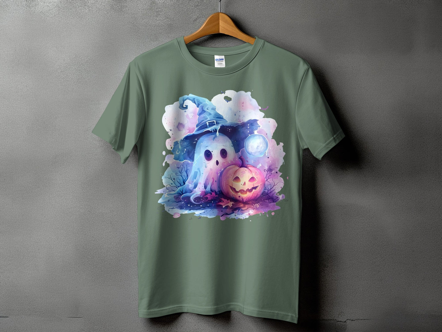 Ghost in a witch hat with pumpkin and moon on a green t-shirt.