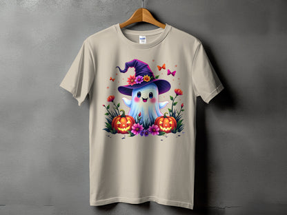 Ghost with witch hat, pumpkins, flowers, and butterflies on a tan t-shirt.
