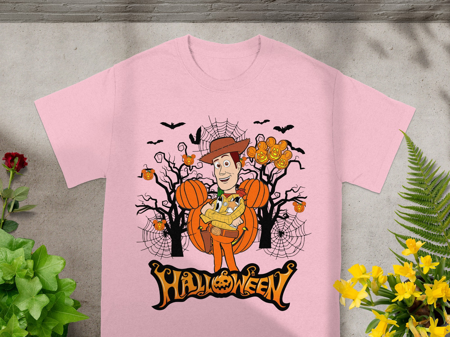 Pink t-shirt with Woody character in Halloween graphic and "Halloween" text.